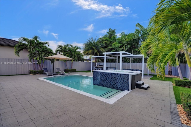 view of pool featuring a patio, a fenced backyard, a fenced in pool, and an outdoor hot tub