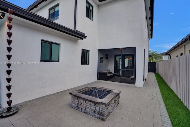 14631 SW 20th St, Miami, FL 33175 - back of house with a fenced backyard, stucco siding, an outdoor fire pit, and a patio area