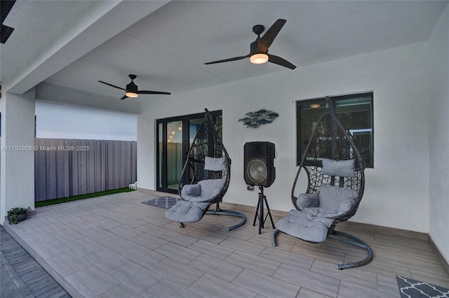 view of patio featuring fence and a ceiling fan