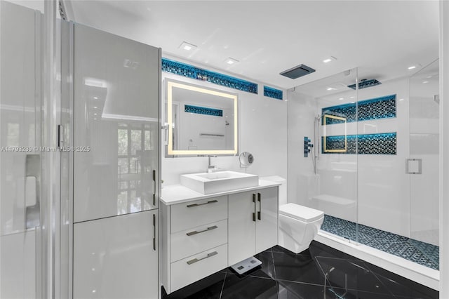 bathroom featuring toilet, a shower stall, and vanity