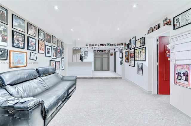 living area featuring recessed lighting and baseboards