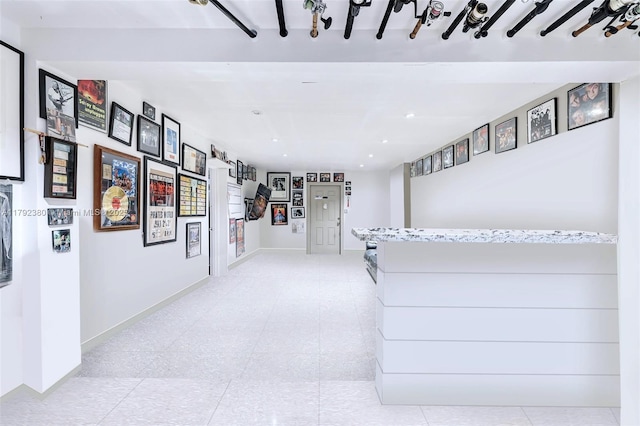 hall with baseboards and recessed lighting