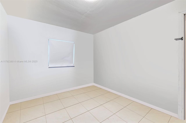 unfurnished room featuring baseboards