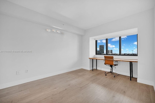 650 NE 32nd St Unit 1004, Miami, FL 33137 - unfurnished office featuring baseboards and wood finished floors