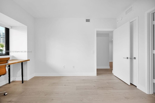 650 NE 32nd St Unit 1004, Miami, FL 33137 - unfurnished bedroom with baseboards, visible vents, and wood finished floors
