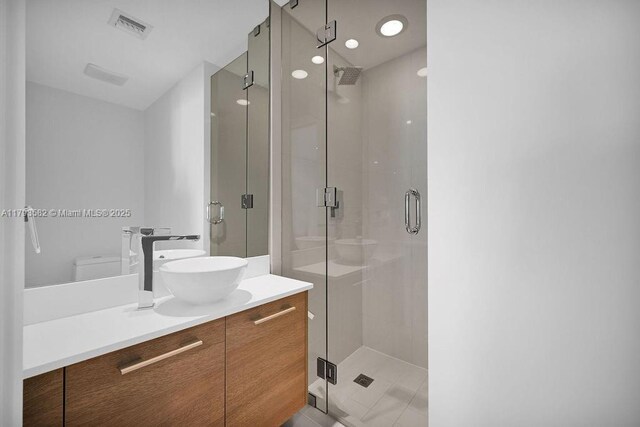 650 NE 32nd St Unit 1004, Miami, FL 33137 - full bath featuring visible vents, a shower stall, toilet, and vanity