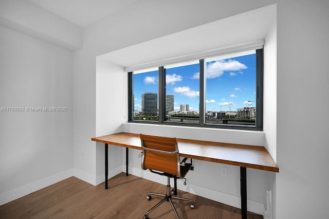 650 NE 32nd St Unit 1004, Miami, FL 33137 - office featuring baseboards, a wealth of natural light, built in desk, and wood finished floors