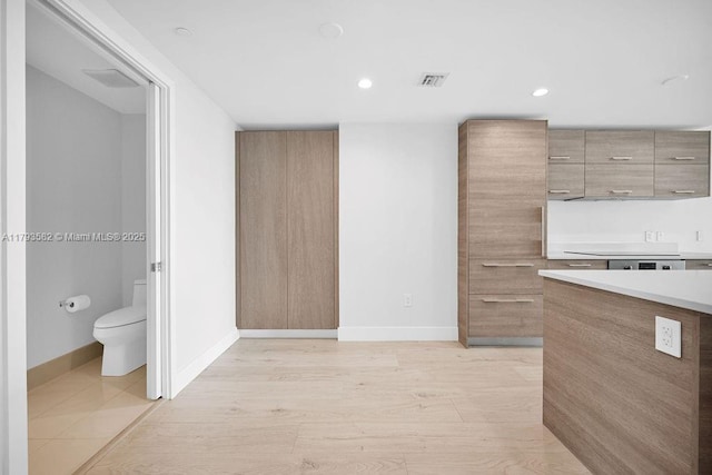 650 NE 32nd St Unit 1004, Miami, FL 33137 - kitchen featuring visible vents, light countertops, baseboards, light wood-style floors, and recessed lighting