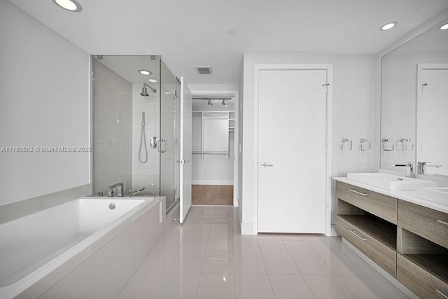650 NE 32nd St Unit 1004, Miami, FL 33137 - bathroom with visible vents, a bath, tile patterned floors, a shower stall, and a sink