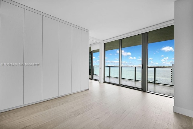 650 NE 32nd St Unit 1004, Miami, FL 33137 - interior space with floor to ceiling windows, a water view, and wood finished floors