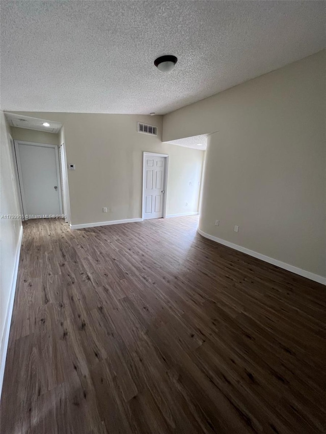 13776 SW 149 Circle Ln Unit 4-79, Miami, FL 33186 - empty room with baseboards, a textured ceiling, visible vents, and dark wood finished floors