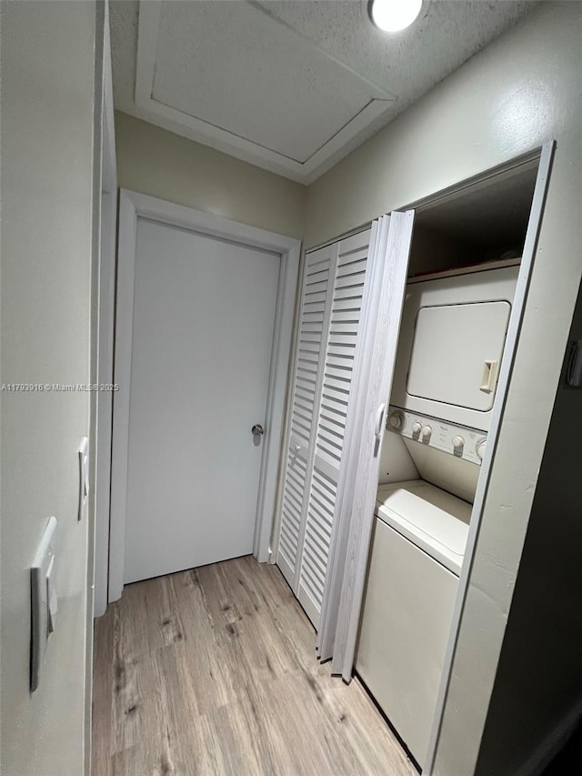 13776 SW 149 Circle Ln Unit 4-79, Miami, FL 33186 - washroom featuring laundry area, attic access, stacked washer and dryer, and light wood-style flooring