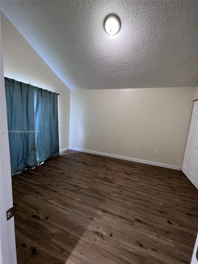 13776 SW 149 Circle Ln Unit 4-79, Miami, FL 33186 - additional living space featuring baseboards, a textured ceiling, dark wood-style floors, and vaulted ceiling
