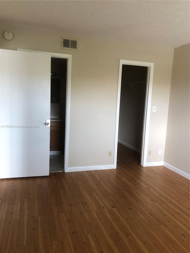 9044 NW 28th Dr Unit 3-202, Coral Springs, FL 33065 - empty room featuring a smoke detector, dark wood finished floors, baseboards, and a textured ceiling