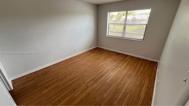 9044 NW 28th Dr Unit 3-202, Coral Springs, FL 33065 - unfurnished room featuring wood finished floors and baseboards