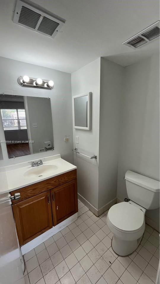 9044 NW 28th Dr Unit 3-202, Coral Springs, FL 33065 - half bathroom with toilet, vanity, and tile patterned floors