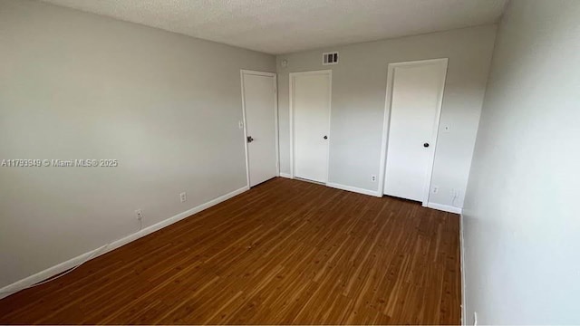 9044 NW 28th Dr Unit 3-202, Coral Springs, FL 33065 - unfurnished bedroom featuring hardwood / wood-style floors and baseboards