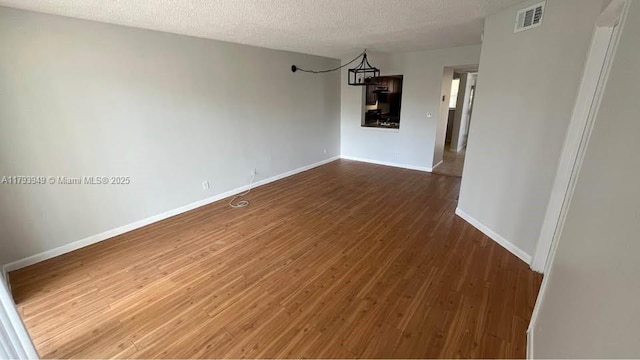 9044 NW 28th Dr Unit 3-202, Coral Springs, FL 33065 - spare room with dark wood-style flooring, a textured ceiling, and baseboards