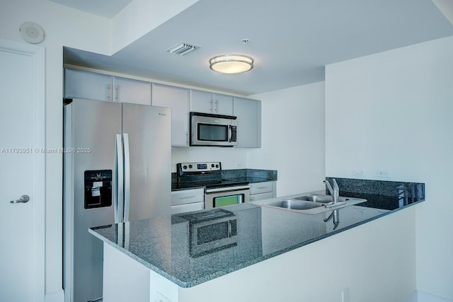 1861 NW S River Dr Unit 1903, Miami, FL 33125 - kitchen with gray cabinets, visible vents, a sink, a peninsula, and stainless steel appliances