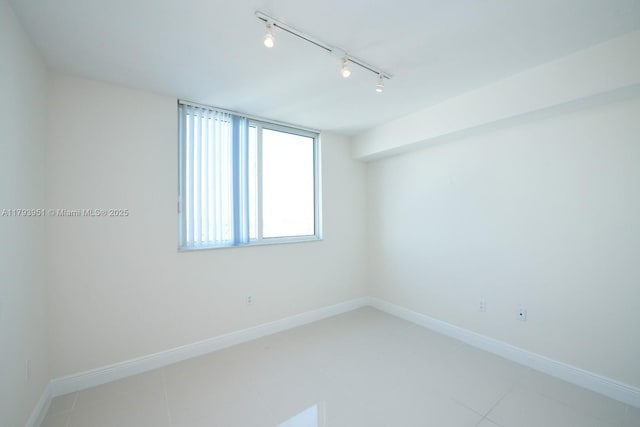1861 NW S River Dr Unit 1903, Miami, FL 33125 - spare room with baseboards, rail lighting, and light tile patterned flooring