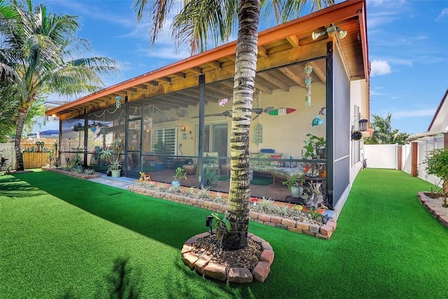 exterior space with a sunroom and a fenced backyard