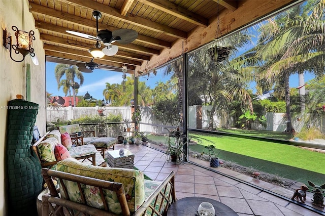 sunroom featuring an outdoor hangout area, a ceiling fan, and beamed ceiling