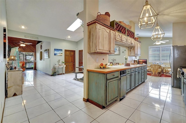kitchen featuring light tile patterned floors, pendant lighting, ceiling fan with notable chandelier, and recessed lighting