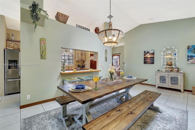 dining space featuring light tile patterned floors, baseboards, an inviting chandelier, and vaulted ceiling