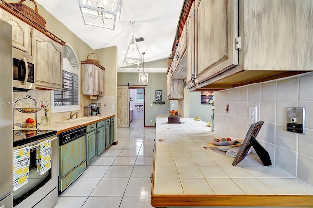 kitchen with range with electric cooktop, a barn door, light tile patterned floors, stainless steel microwave, and dishwashing machine