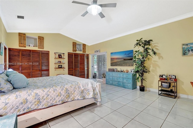 bedroom with crown molding, baseboards, vaulted ceiling, and light tile patterned floors