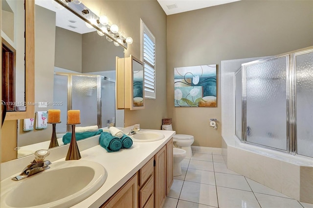 bathroom with a sink, toilet, a bidet, and double vanity