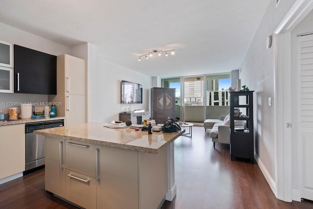 500 NE 29th St Unit 606, Miami, FL 33137 - kitchen with glass insert cabinets, a center island, dark wood-type flooring, light stone counters, and dishwasher