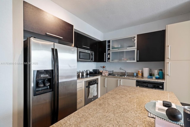 500 NE 29th St Unit 606, Miami, FL 33137 - kitchen featuring light stone counters, a sink, stainless steel appliances, a kitchen bar, and glass insert cabinets