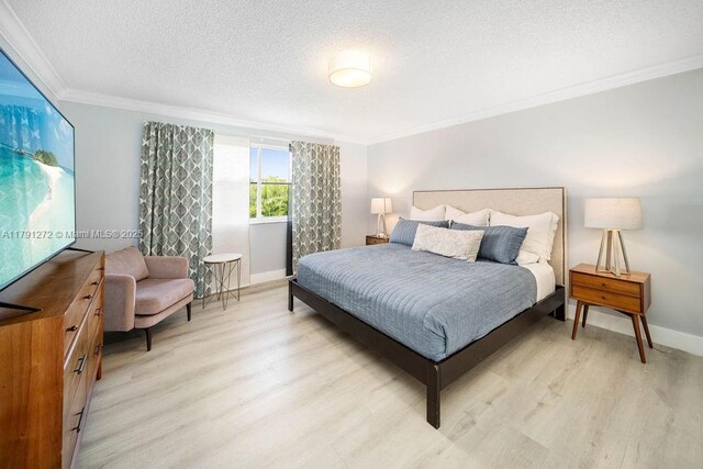 721 Tanglewood Cir, Weston, FL 33327 - bedroom featuring crown molding, baseboards, light wood finished floors, and a textured ceiling
