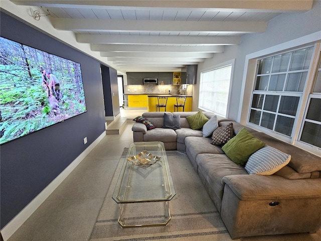 home theater featuring baseboards and beam ceiling
