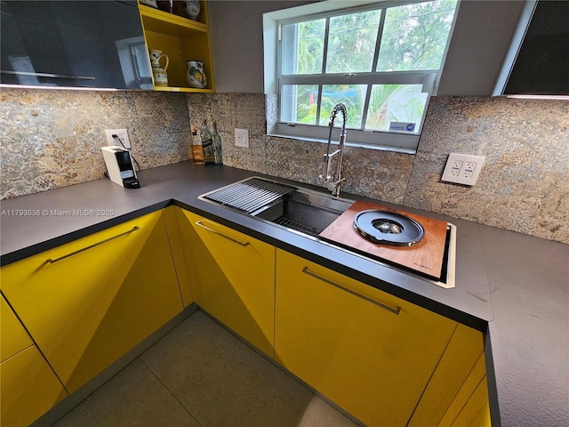 kitchen with dark countertops, decorative backsplash, and open shelves