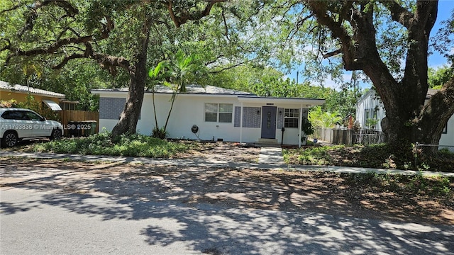 12120 NE 11th Pl, North Miami, FL 33161 - view of front of house featuring fence, stucco siding, and driveway