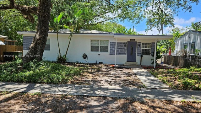 12120 NE 11th Pl, North Miami, FL 33161 - ranch-style home with fence, stucco siding, and entry steps