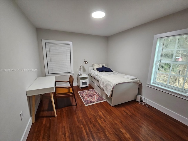bedroom featuring baseboards and wood finished floors