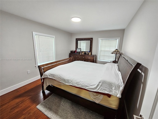 bedroom with baseboards and wood finished floors