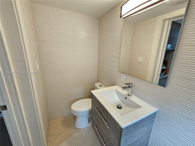 12120 NE 11th Pl, North Miami, FL 33161 - half bathroom featuring vanity, toilet, and tile walls