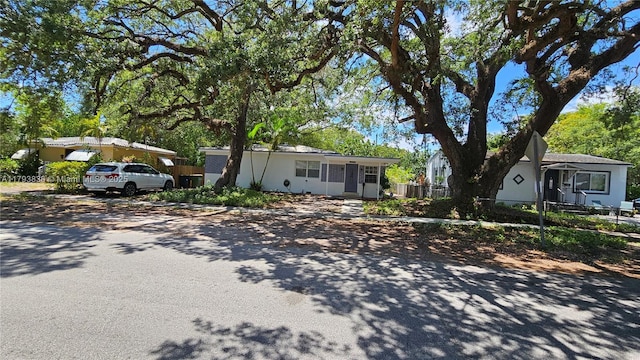 ranch-style home with fence