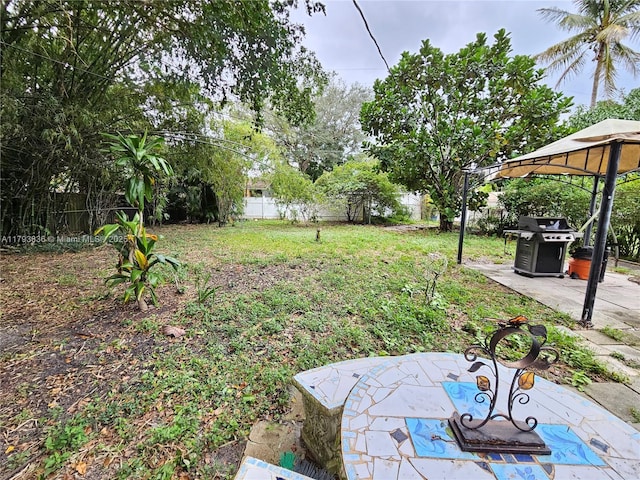 view of yard featuring a gazebo, a fenced backyard, and a patio area