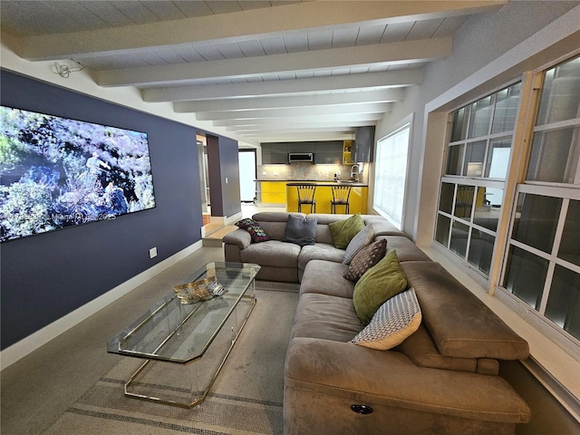 home theater with beamed ceiling and baseboards