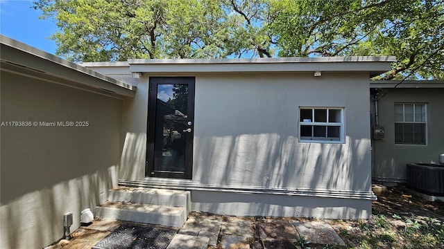 12120 NE 11th Pl, North Miami, FL 33161 - doorway to property with cooling unit and stucco siding