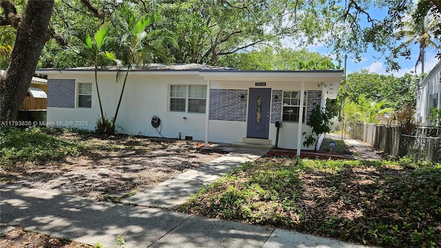 ranch-style home with fence