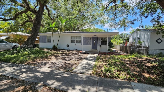 ranch-style home with fence
