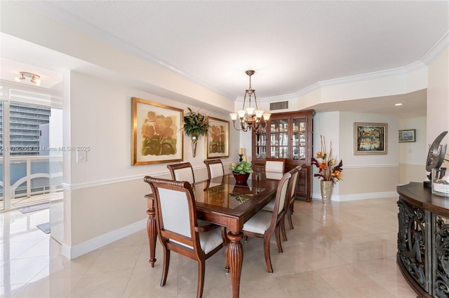 dining space featuring baseboards, ornamental molding, a chandelier, and visible vents