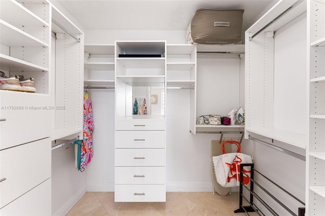 walk in closet featuring light tile patterned floors