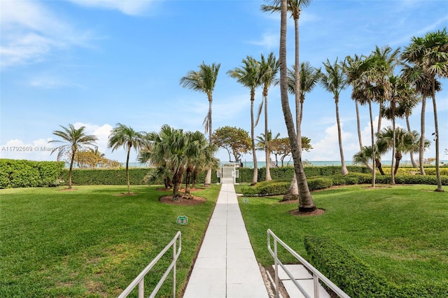 surrounding community featuring a lawn and a water view
